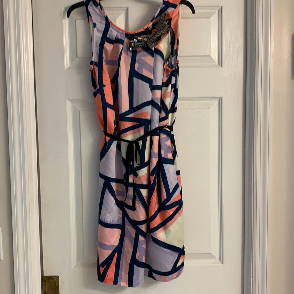 A sleeveless multicolor belted dress.